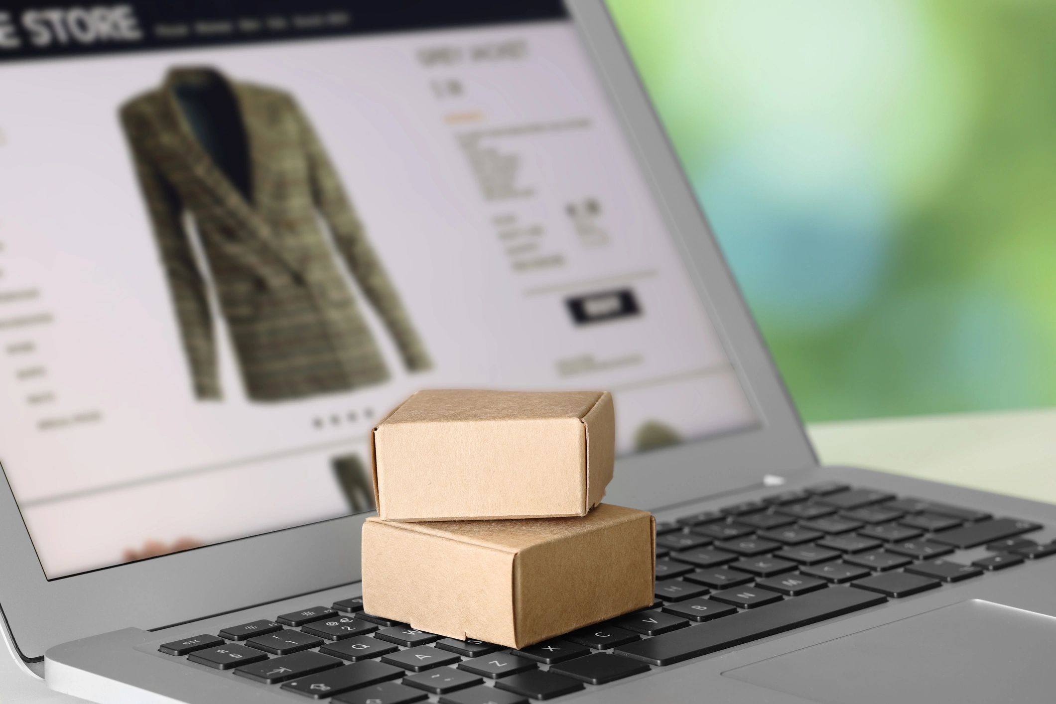 Mini boxes on laptop, closeup. Online store